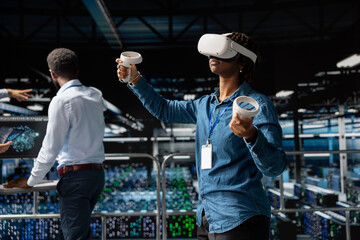 African american woman works with VR headset in modern server farm, ensuring artificial intelligence automation with computer science and programming. Machine learning supercomputers.
