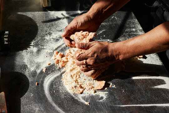 Horizontal high angle view shot of unrecognizable mature man working in restaurant kitchen preparing dough for pasta