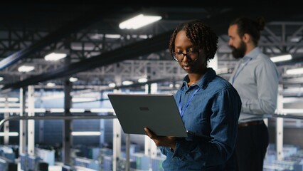 Data center software developers using devices to review AI LLM visualizations. IT professionals working together to analyze neural networks outputs, ensuring stable gear operations