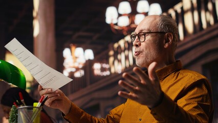 Aged performer engaged in dramaturgy and script practice with lines, demonstrating creativity and discipline during drama rehearsal. Passion for storytelling and reenactment. © DC Studio