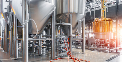 Industrial brewery factory with stainless steel tanks and equipment in operation