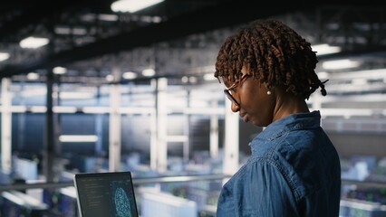 Data center coworkers doing maintenance on mainframes handling AI processing tasks. Server hub system administrators managing storage arrays supporting deep learning training workflows