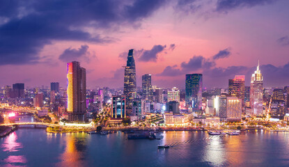 Fototapeta premium Aerial view panoramic of Ho chi minh or Saigon city at sunset in Vietnam, illuminated skyscrapers with sunlight