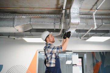 Hvac technician installing air conditioning and ventilation system