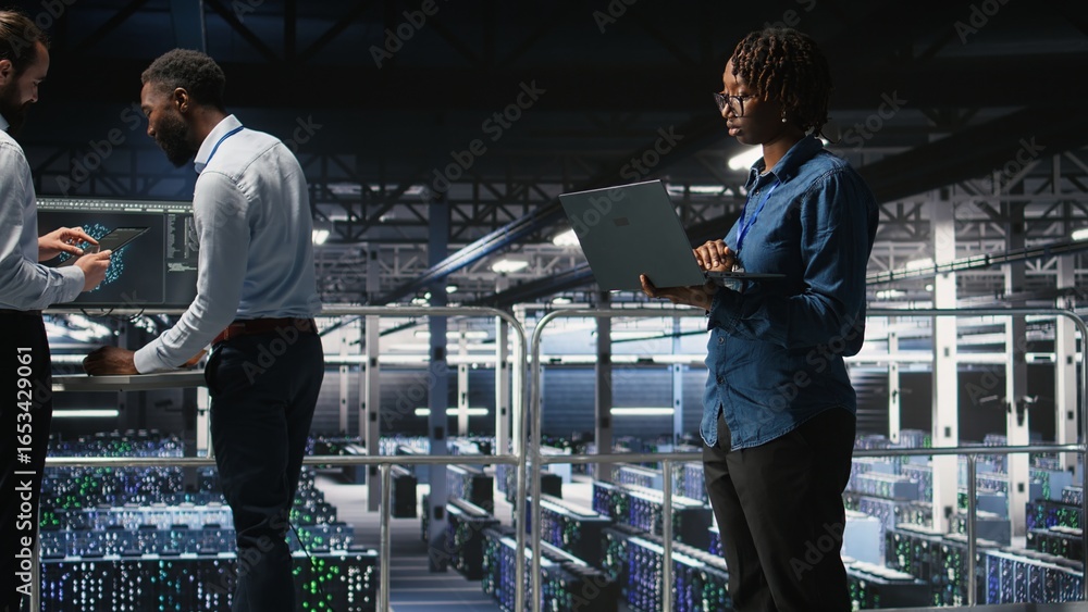 Poster data center system administrators doing maintenance tasks on laptop, ensuring optimal performance. i