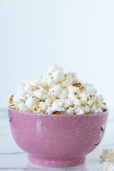 Popcorn in bowl with white background. Copy space. Close-up.