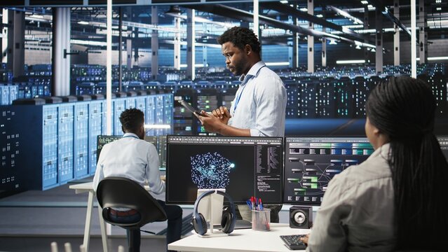 Server farm technician using AI algorithms and node tree systems to categorize unstructured data. Data center worker uses visual programming and natural language processing tools, camera A