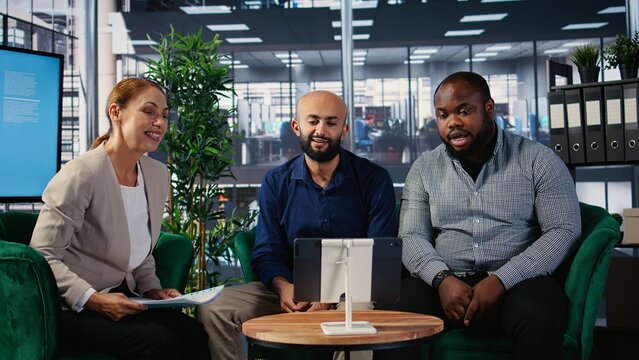 Corporate web video conference with diverse participants focused on goal oriented business growth, remote consulting and functional team interaction via online communication tools. Camera A.