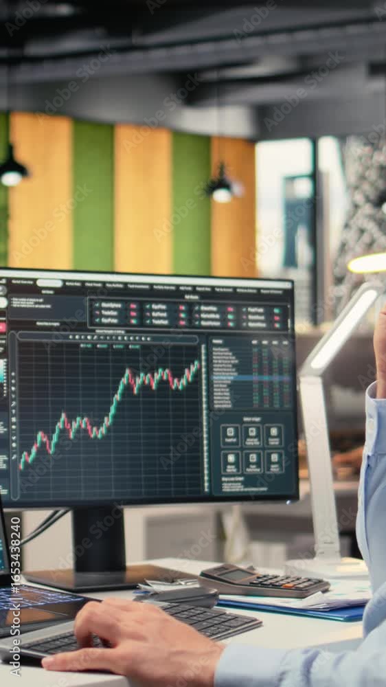 Poster vertical video portfolio manager in office using ai software on laptop to evaluate capital allocatio