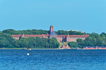 Marine Fernmeldeschule in Flensburg with historic gateway towers and arch overlooking the sea