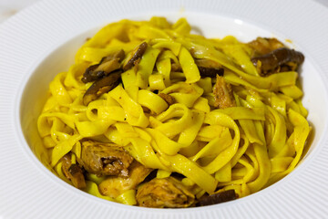 Creamy mushroom and fish Mediterranean Italian Tagliatelle Pasta close up	