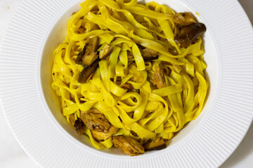 Creamy mushroom and fish Mediterranean Italian Tagliatelle Pasta close up	