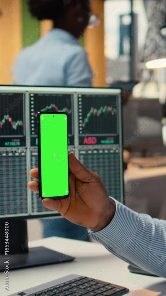 Poster vertical video trader in prop firm office attends virtual meeting using green screen mobile phone. a
