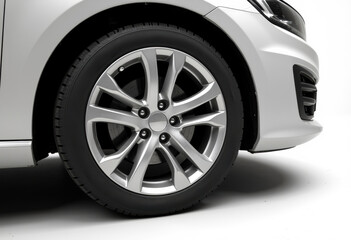 Obraz premium Close-up of a modern car wheel and tire on a white background