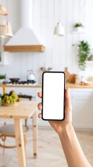 Hand holding a phone in a kitchen