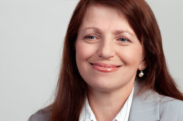 Fototapeta premium Beautiful successful business woman with happy smile posing in suit