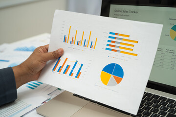 Asian business woman working with financial graph.