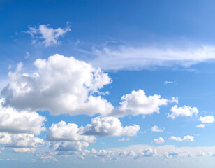 Serene Summer Sky: Bright Blue, Puffy Cumulus Clouds, Peaceful Atmosphere, Wide Shot, Natural Light, Horizontal Format.
