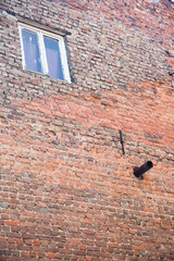 Rustic red brick wall with wooden glass window