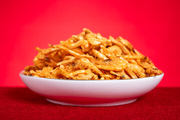 angle view dish of freeze-dried Antarctic krill as cat treats on red