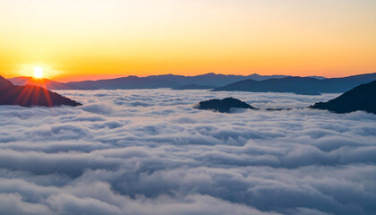 Serene Sunrise Over Mountains and Cloudscape: Breathtaking Panoramic View of Golden Hour Light, Peaceful Atmosphere, and Dramatic Silhouetted Peaks.