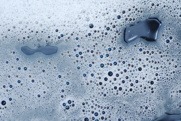 Macro shot of bond between soap bubbles as background