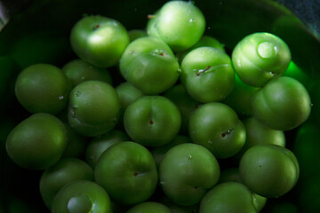 Stack of sour green plums