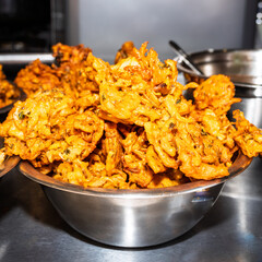 Fresh onion bhaji's in a stainless steel bowl