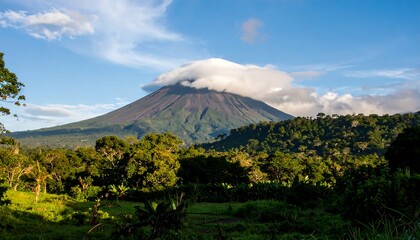 Fototapeta premium Volcanic peak with clouds. Lush landscape
