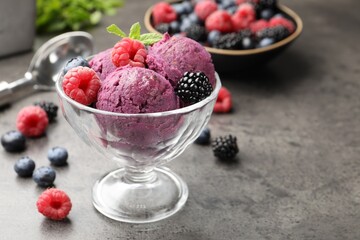 Delicious sorbet with fresh berries and mint in dessert bowl on grey textured table, closeup