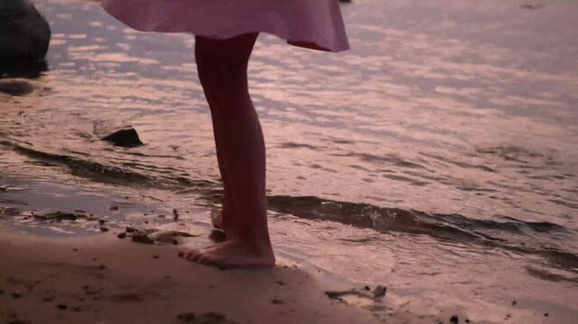 closeup of woman legs dancing on sandy beach