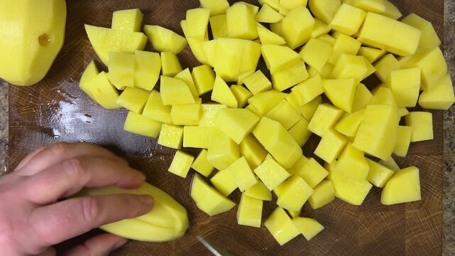 chef chops potatoes with a knife.