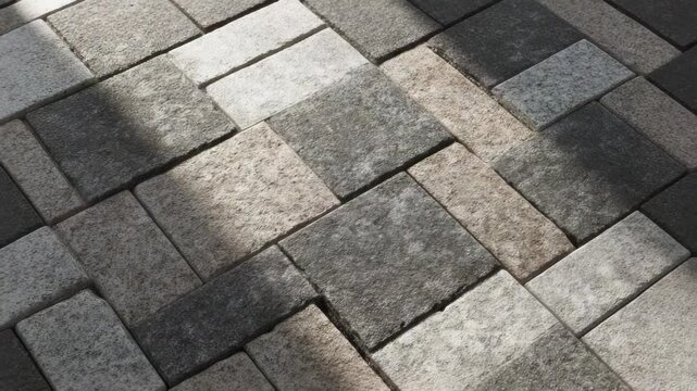 Close-Up of Interlocking Pavers in a Herringbone Pattern with subtle color variations