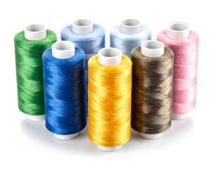 Colorful spools of thread arranged on a white background