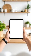 Hands holding a tablet in a kitchen (1)