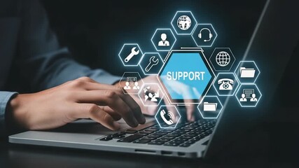 Person typing on laptop with support icons overlayed on screen in a digital assistance concept - Powered by Adobe