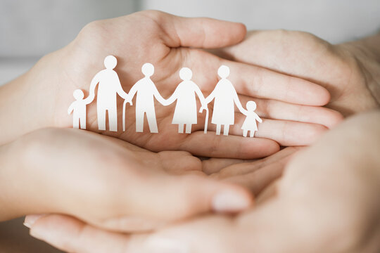 Hands holding multi generational family paper shape, family wellness, health insurance concept
 - Powered by Adobe