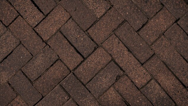 Brown brick pavers in a herringbone pattern on a floor surface