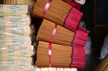 Bundles of traditional incense sticks with red tips for religious ceremonies, meditation and...