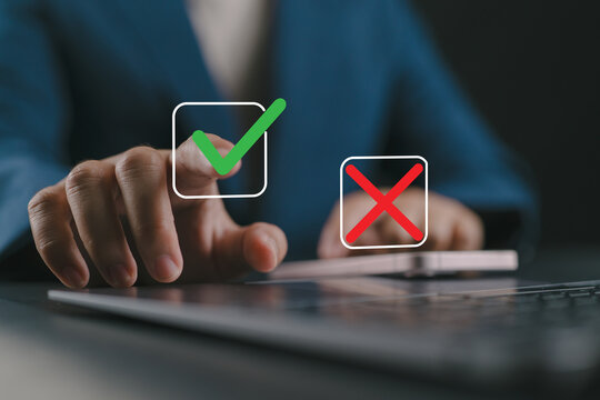 Select the check mark on a laptop. Check right and wrong marks. Concept decide to choose vote. Yes or no decisions, and business options for difficult situations in dilemma.
