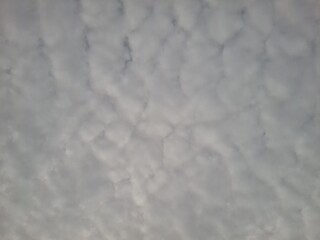 Cloudy sky with dramatic cracks of sunrise light breaking