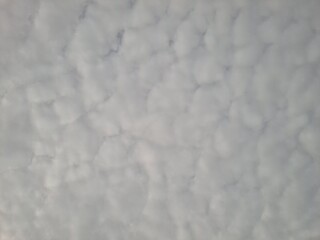 Cloudy sky with dramatic cracks of sunrise light breaking