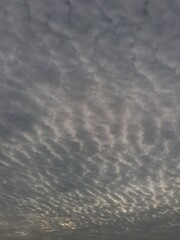 Cloudy sky with dramatic cracks of sunrise light breaking