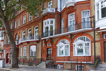 Chelsea district of London, distinctive old apartment buildings with multi-color bricks
