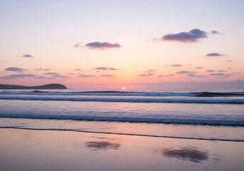 Fototapeta premium Tranquil coastal vista featuring a pastel-colored sunset and gentle waves