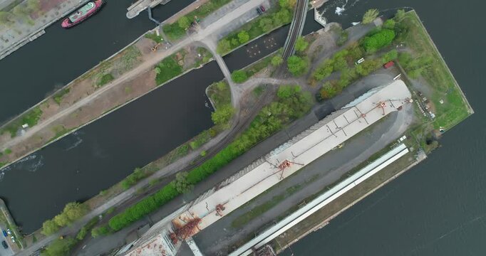 Aerial view of an abandoned industrial dock on the Lachine canal, Old Montreal, Montreal, Quebec, Canada. The old factory buildings and cranes are decaying, showing urban decay and the effects of time