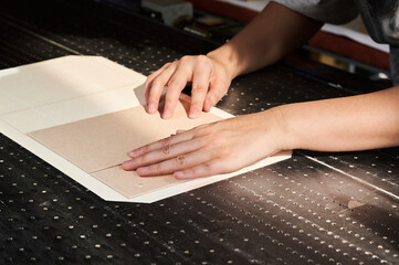 Crafting custom boxes in a box manufacturing plant with skilled hands in action