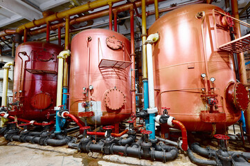 Industrial tanks and piping system in a facility showing the inner workings of a production process