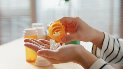 Taking Medicines pill from prescribe bottle. closeup hand with many supplement pills healthy lifestyle