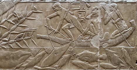 Ancient Egyptian hieroglyphic carvings engraved on a stone wall.